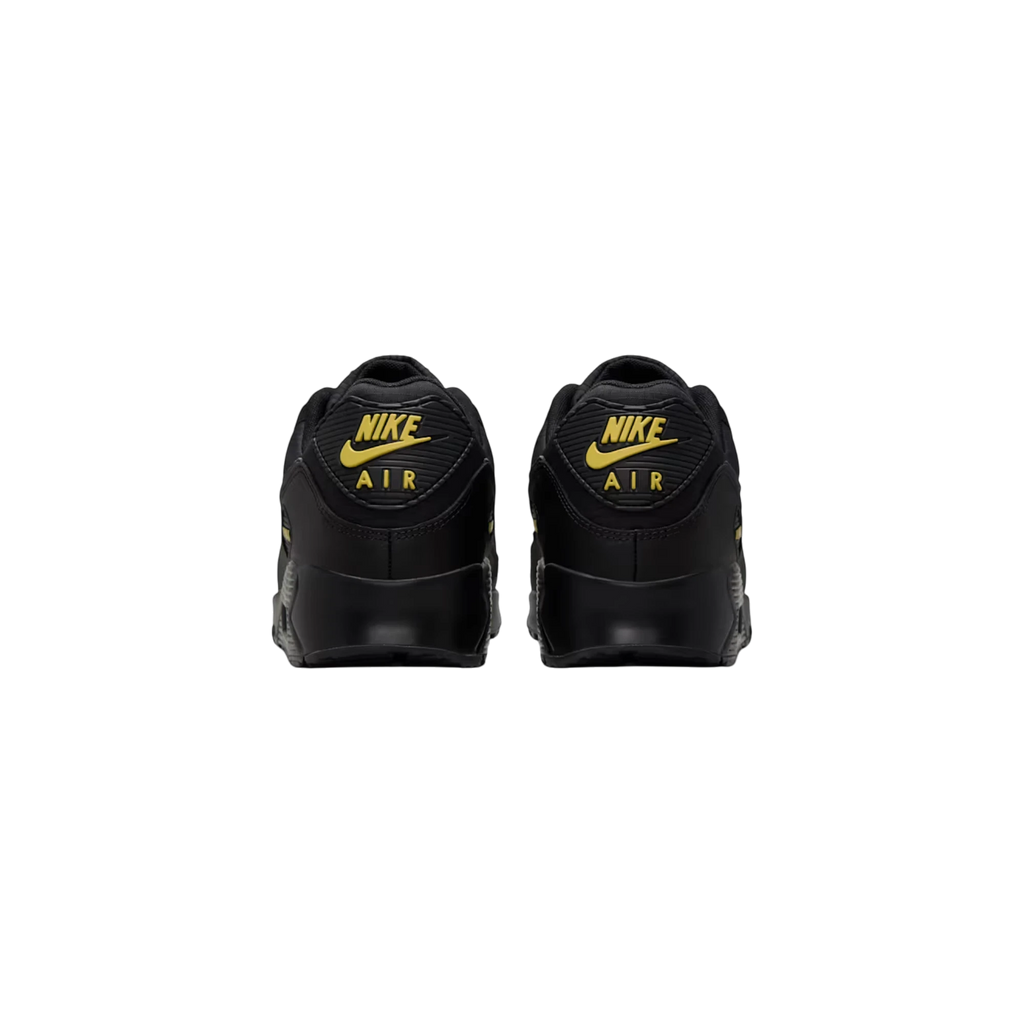 Vista trasera de las zapatillas THE KICKS WORLD Nike Air Max 90 en color negro con detalles en dorado Buff Gold