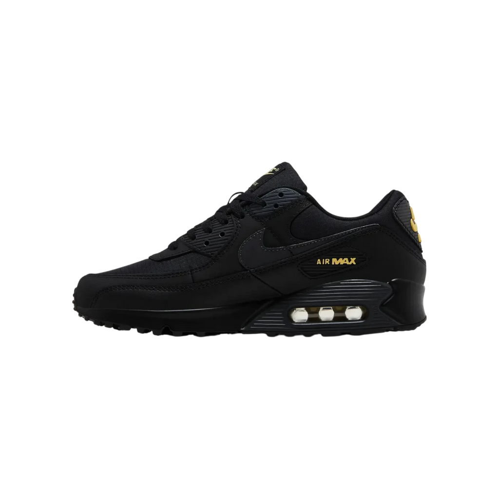 Zapatillas THE KICKS WORLD Nike Air Max 90 en negro con detalles en dorado, diseño urbano de malla y piel.